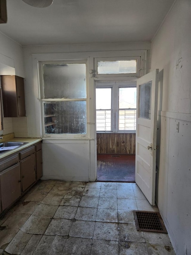 kitchen featuring visible vents, light countertops, and a sink