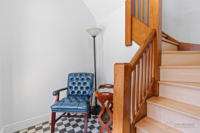 stairs featuring lofted ceiling and baseboards