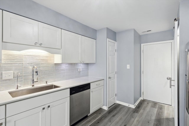 kitchen with a sink, white cabinetry, light countertops, and stainless steel dishwasher