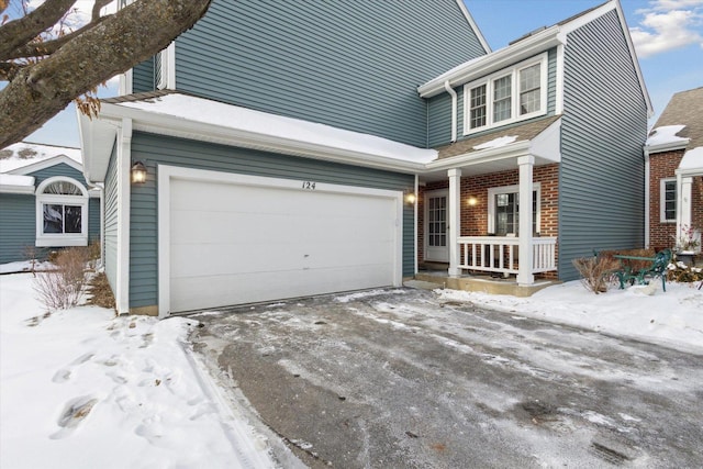 view of front of property with a garage, brick siding, and a porch