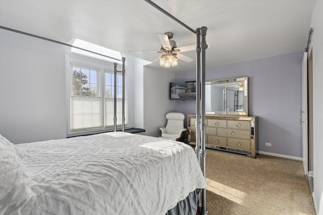 carpeted bedroom with ceiling fan and baseboards