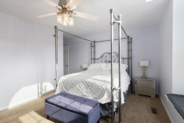 carpeted bedroom with ceiling fan, visible vents, and baseboards