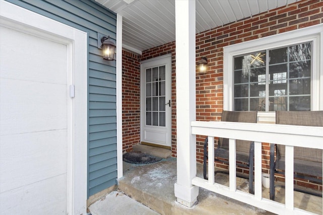 entrance to property featuring brick siding