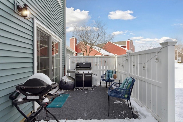 view of patio with area for grilling and a fenced backyard