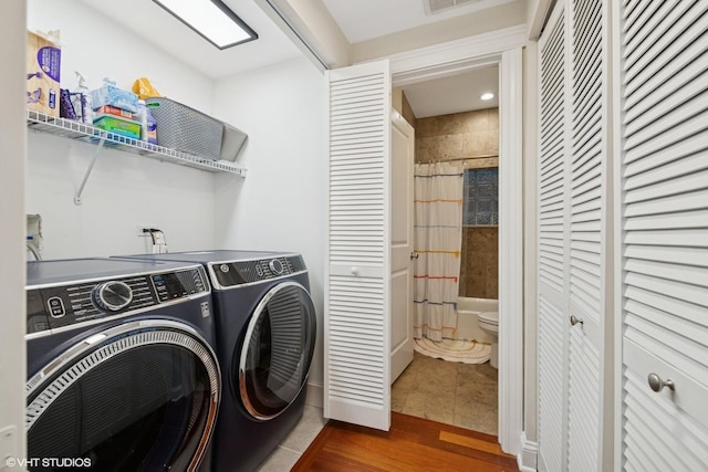 1418 W Chestnut St Unit 1, Chicago, IL 60642 - laundry room with washing machine and clothes dryer and tile patterned floors
