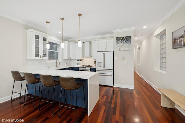 1418 W Chestnut St Unit 1, Chicago, IL 60642 - kitchen with high end white fridge, a peninsula, a kitchen breakfast bar, white cabinets, and ornamental molding