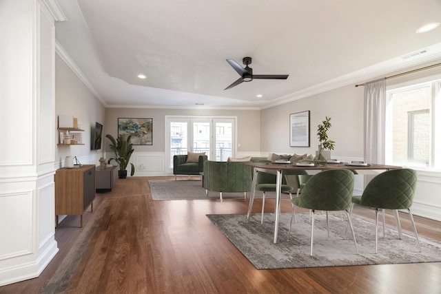 dining room with recessed lighting, a wainscoted wall, a decorative wall, ornamental molding, and dark wood-style floors