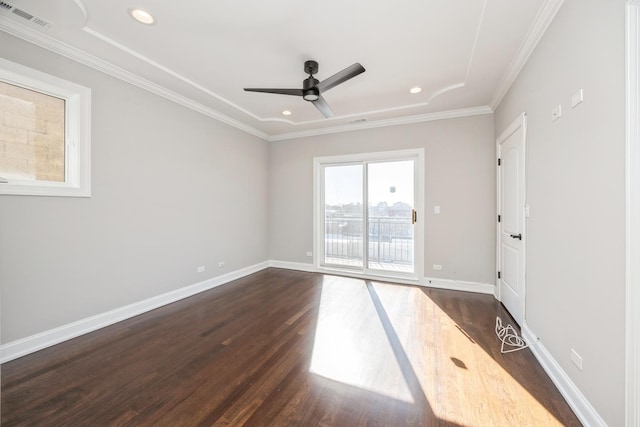 empty room with baseboards, visible vents, a ceiling fan, ornamental molding, and dark wood-style flooring