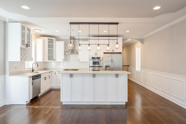 kitchen featuring a center island, light countertops, appliances with stainless steel finishes, glass insert cabinets, and white cabinets