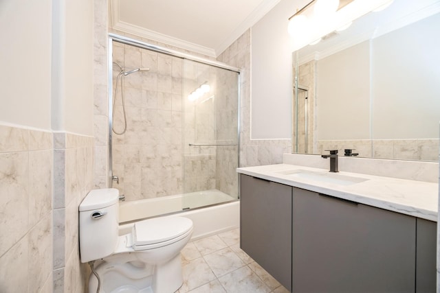 bathroom with toilet, ornamental molding, tile walls, and vanity