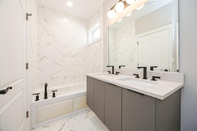 bathroom featuring marble finish floor, double vanity, a sink, and a bath