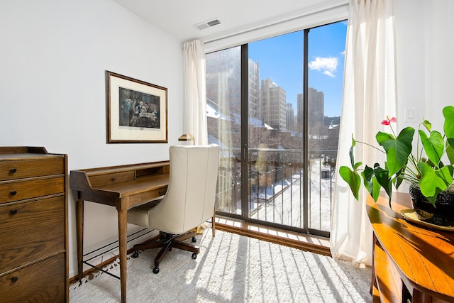 office with a view of city, visible vents, and baseboard heating