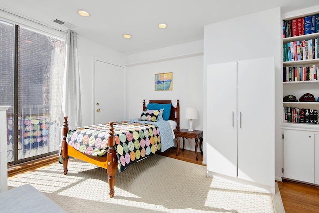 bedroom featuring visible vents, wood finished floors, and recessed lighting