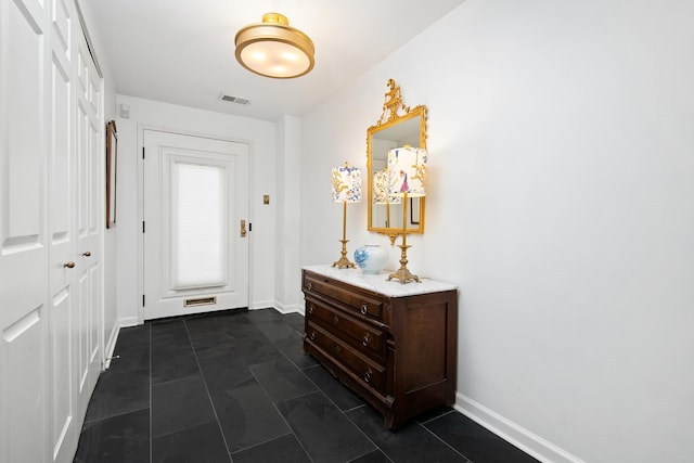 entryway with baseboards and visible vents