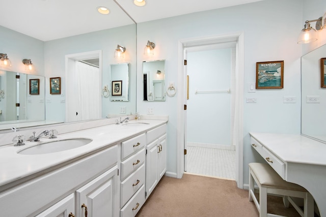 bathroom with recessed lighting, a sink, baseboards, and double vanity