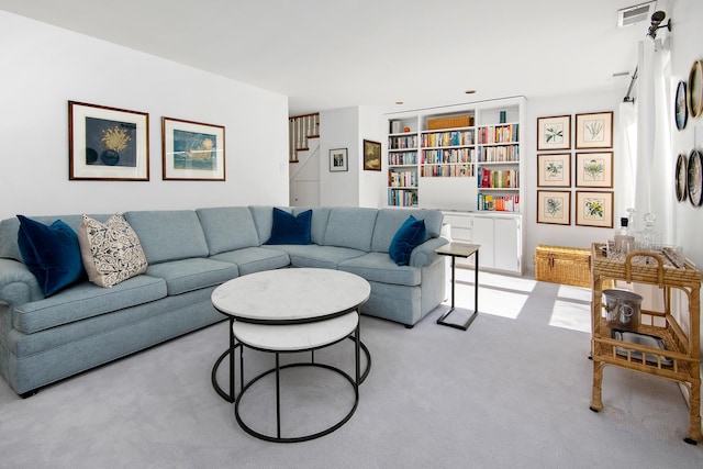 living room with light carpet, stairs, and visible vents