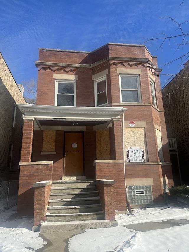 view of property featuring brick siding