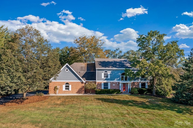 view of front of property featuring brick siding and a front yard