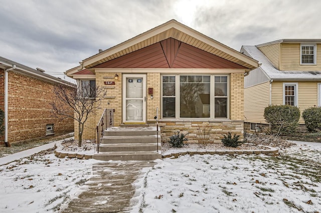 view of front facade featuring stone siding and brick siding