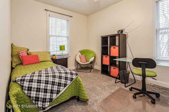 bedroom with carpet flooring, multiple windows, and baseboards