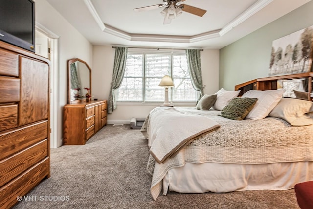 bedroom featuring a tray ceiling, a ceiling fan, carpet flooring, and crown molding