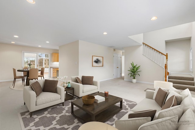 living room featuring light carpet, stairway, and recessed lighting