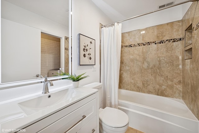 bathroom featuring visible vents, vanity, toilet, and shower / bath combo with shower curtain