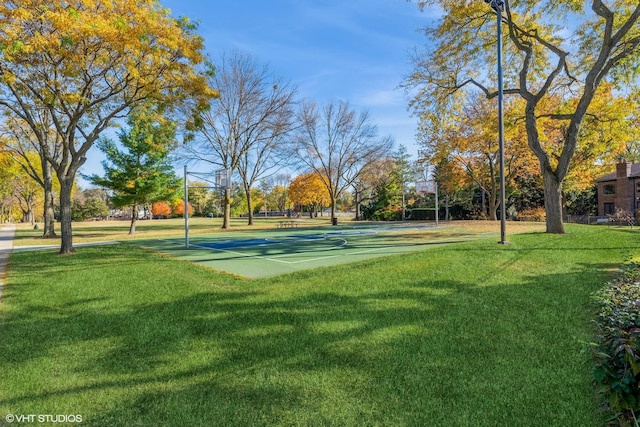 view of property's community featuring community basketball court and a lawn