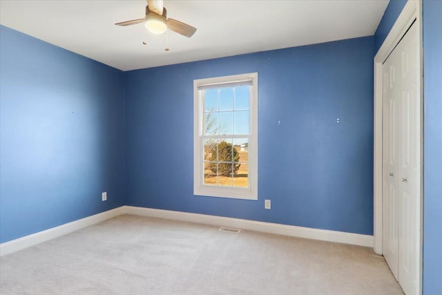 interior space with ceiling fan, visible vents, and baseboards