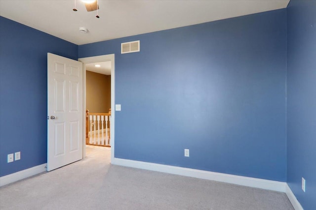 unfurnished room featuring baseboards, visible vents, and carpet flooring