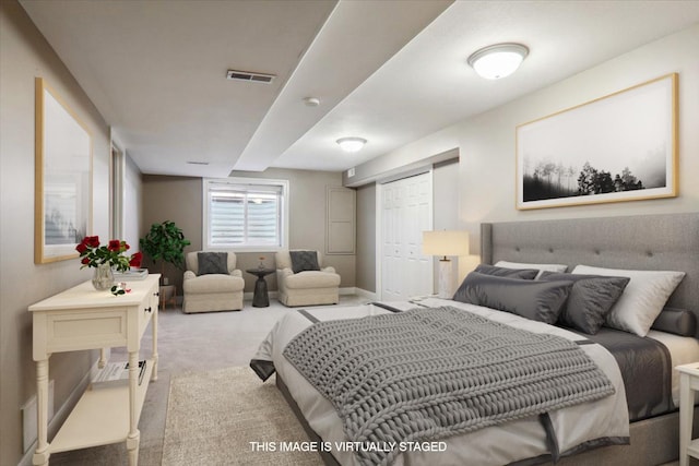 carpeted bedroom featuring a closet, visible vents, and baseboards