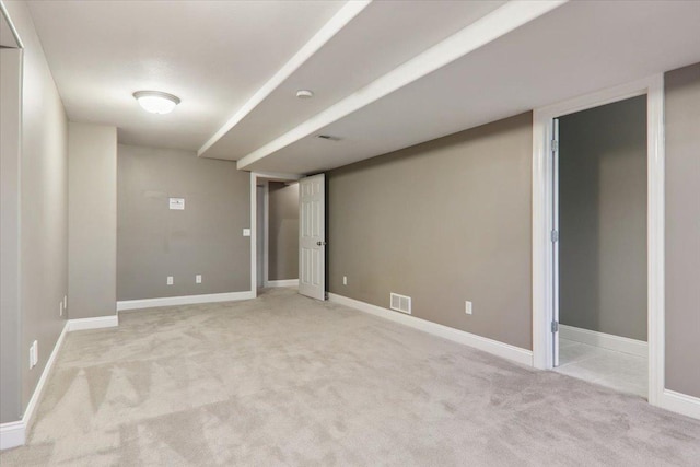 interior space with light carpet, baseboards, and visible vents