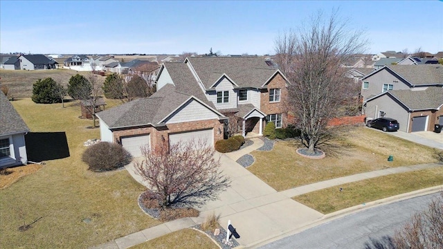 traditional-style home featuring driveway, an attached garage, a residential view, and a front yard