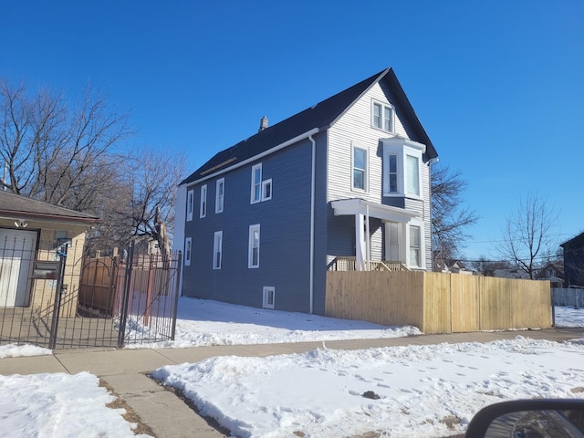 view of snow covered exterior featuring fence