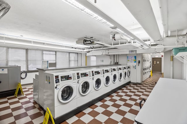 common laundry area with washing machine and dryer and dark floors