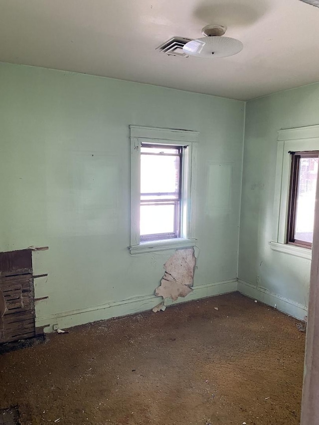 empty room with a healthy amount of sunlight and baseboards