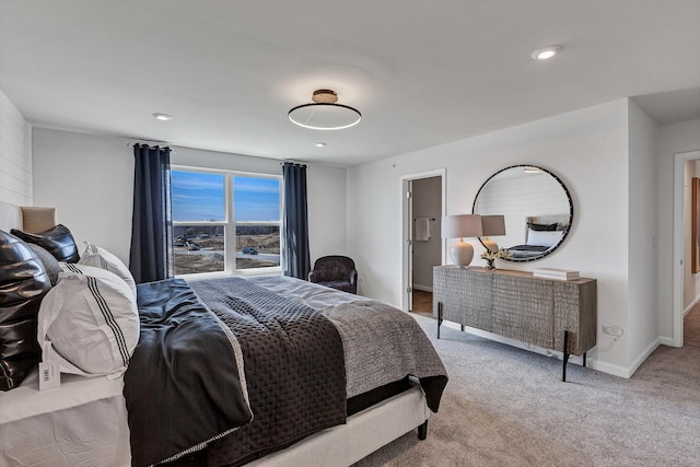 bedroom with light carpet and baseboards