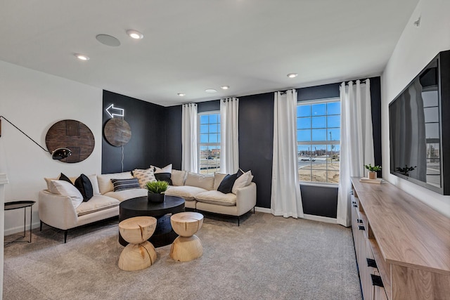 living area featuring recessed lighting, light colored carpet, and baseboards