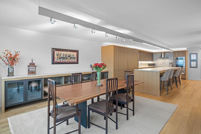 dining room with light wood-style flooring