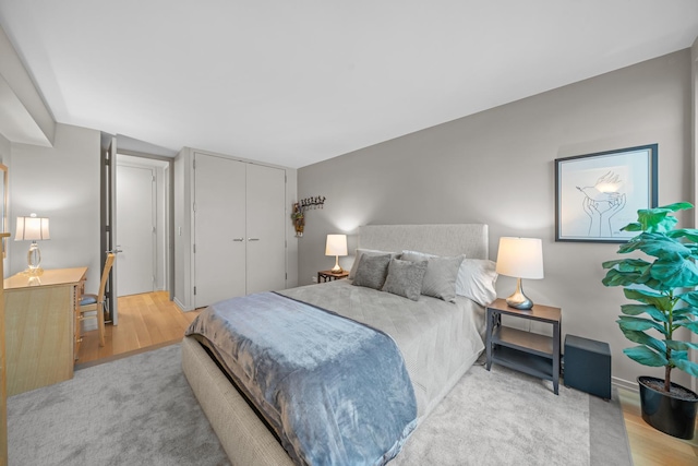 bedroom featuring light wood-style floors and a closet