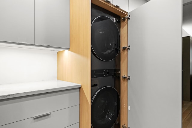 laundry room featuring laundry area and stacked washer / dryer