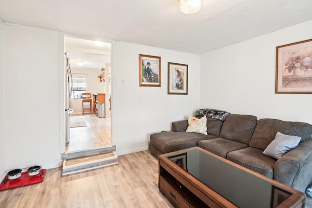 living room with light wood-type flooring and baseboards