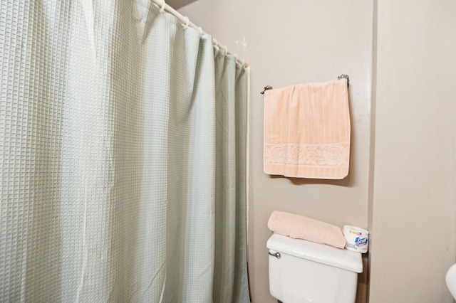 full bathroom with a shower with curtain and toilet