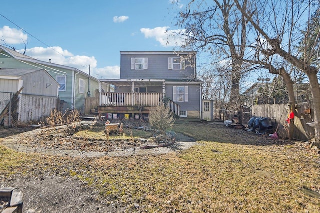 rear view of property with fence and a wooden deck