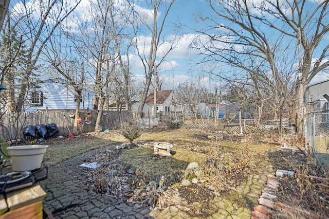 view of yard featuring an outdoor fire pit and a fenced backyard