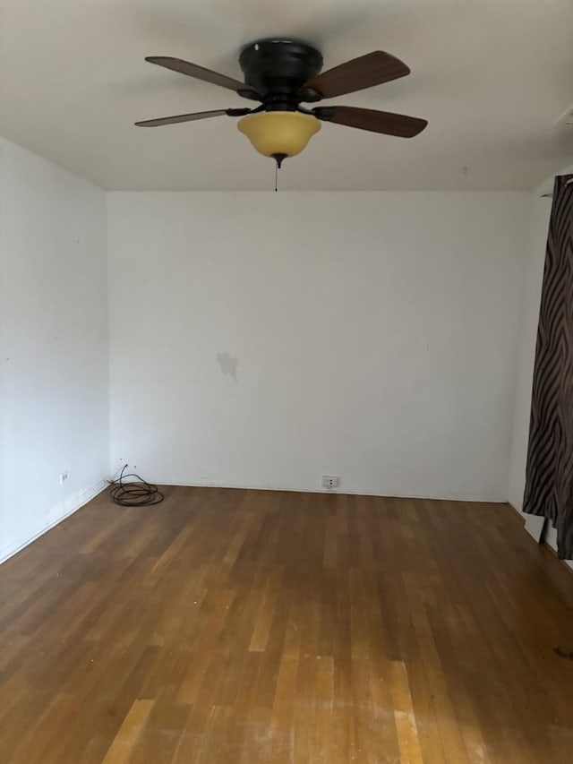 unfurnished room with wood finished floors