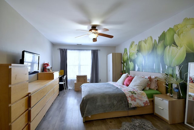 bedroom featuring ceiling fan and dark wood finished floors