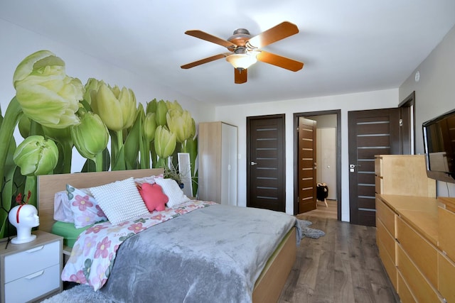 bedroom with ceiling fan and dark wood-type flooring