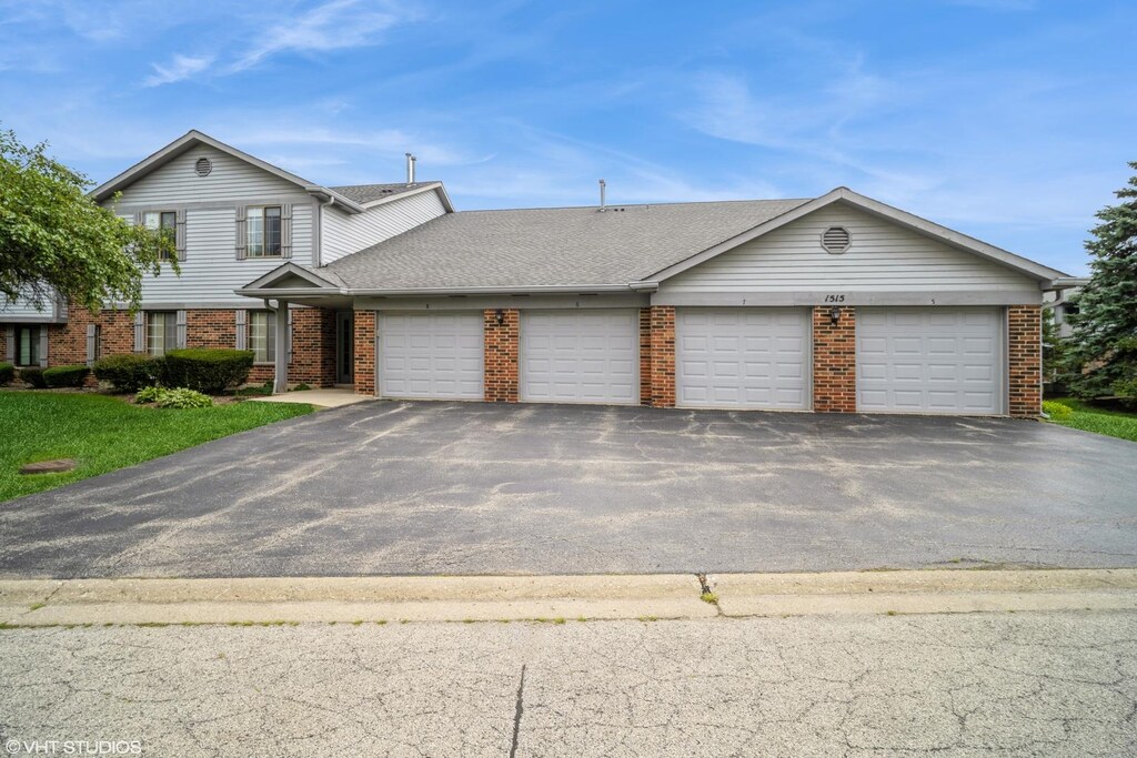 1515 W Pheasant Trail Ln Unit 5, Arlington Heights, IL 60004 - view of front of home with brick siding, an attached garage, aphalt driveway, and a shingled roof
