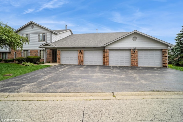 1515 W Pheasant Trail Ln Unit 5, Arlington Heights, IL 60004 - view of front of home with brick siding, an attached garage, aphalt driveway, and a shingled roof
